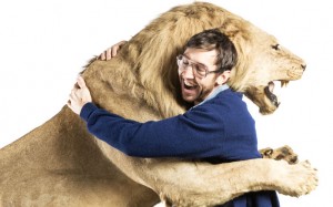 Lion hugging smiling man