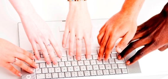 Hands of different people on keyboard